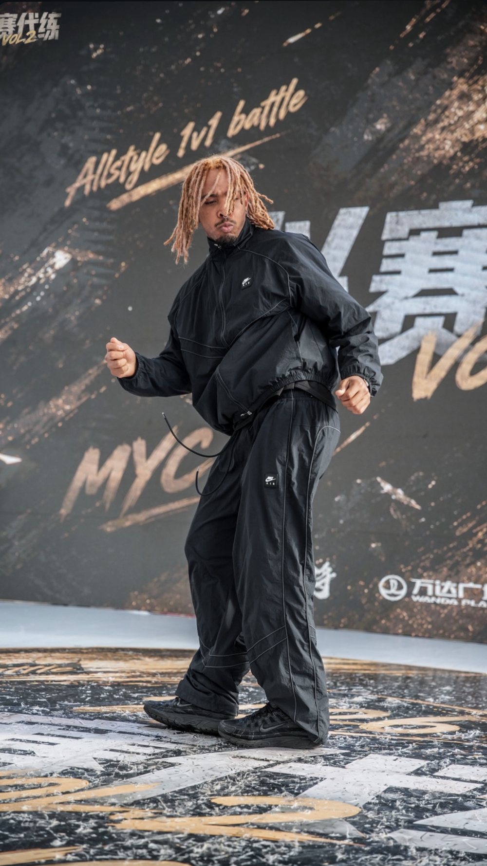 Osmar dancing on stage at an outdoor dance event